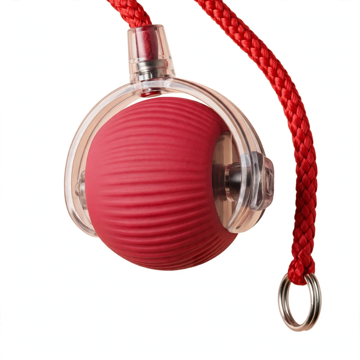 Close-up detail of the red smart rolling ball showing its ribbed silicone texture, transparent outer shell, and braided red rope tail through a metal ring.