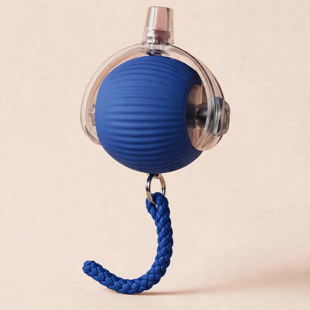 Blue rope-textured smart rolling cat ball with a transparent outer shell, metal USB charging port on top, and a braided blue rope tail hanging below, on a beige background.