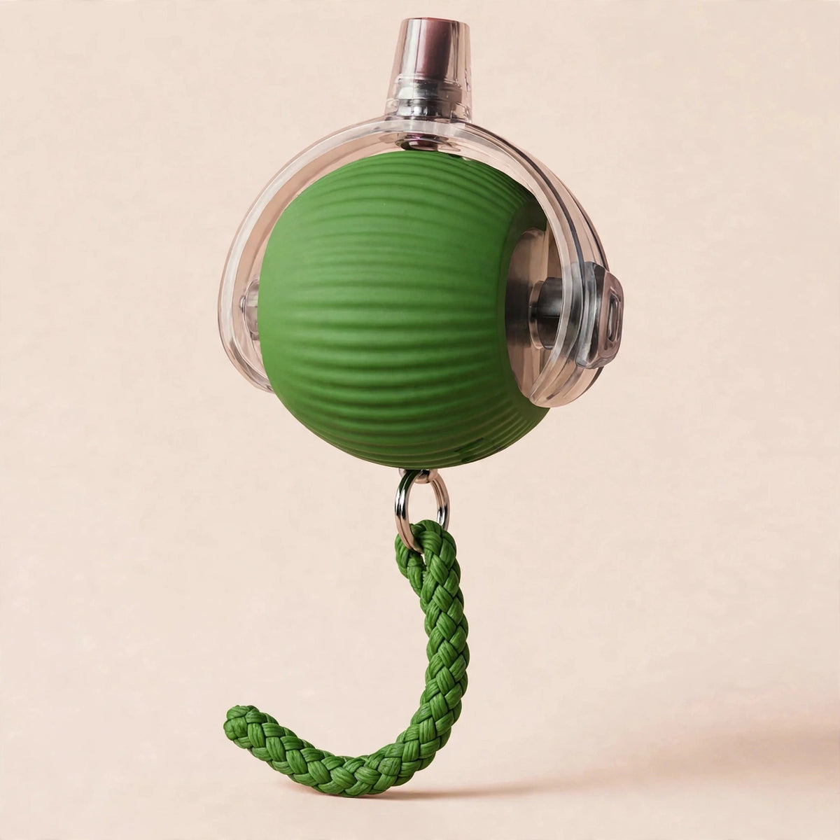 Green rope-textured smart rolling cat ball with a transparent outer shell, metal USB charging port on top, and a braided green rope tail hanging below, on a beige background.